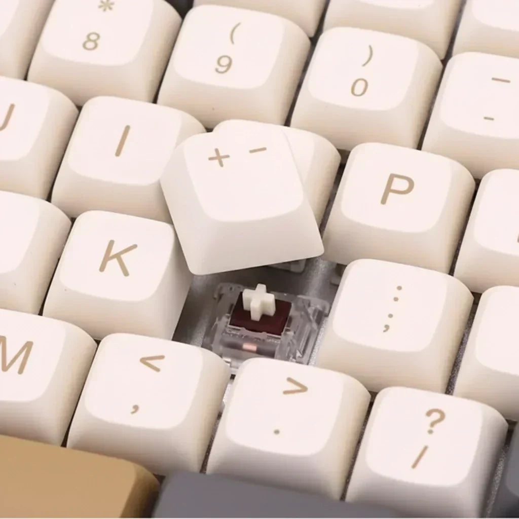 Cream white XDA keycap being pulled off a mechanical keyboard